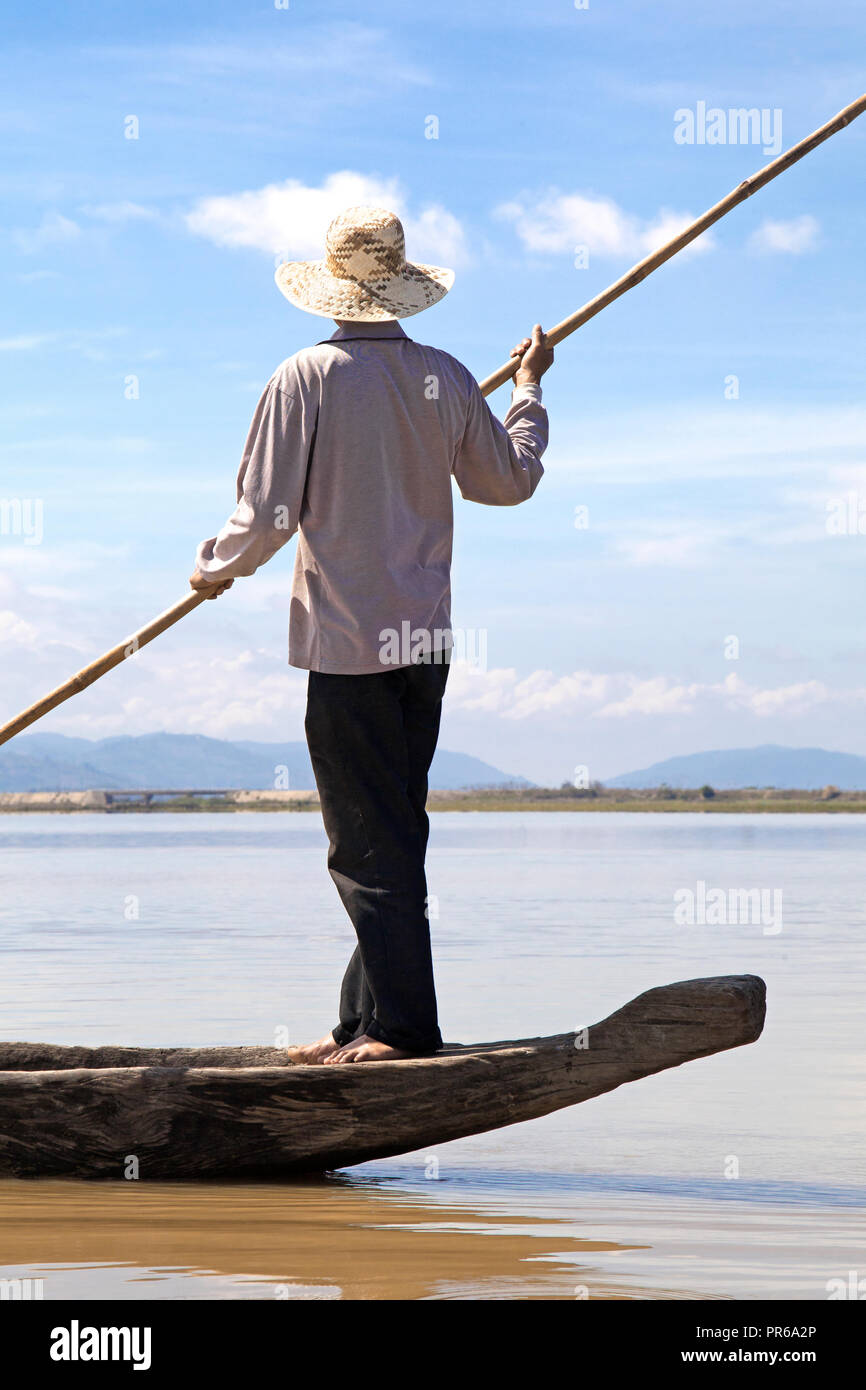 Dak Lak, VIETNAM - 6 janvier 2015 - Homme poussant un bateau avec un pôle Banque D'Images