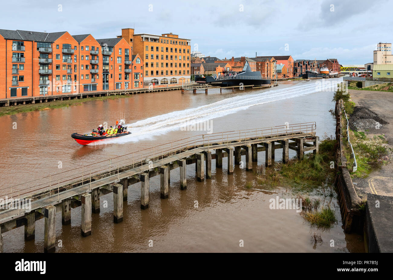 Sauvetage des vitesses gonflable Humber River Hull flanqué d'appartements modernes et des bureaux et les apparaux de pont-jetée, Hull, dans le Yorkshire, UK. Banque D'Images