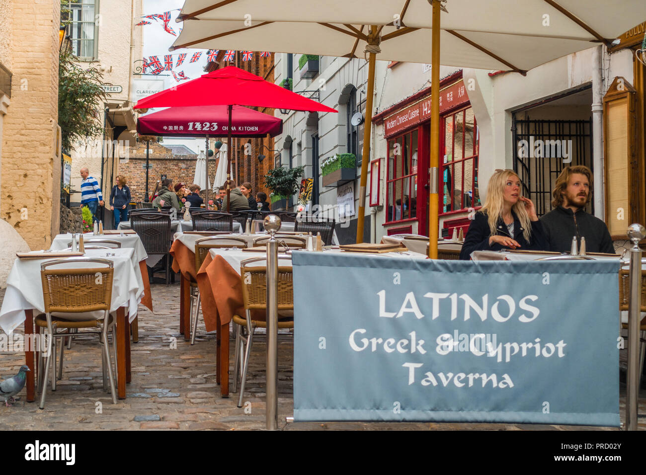 Latinos grec et chypriote Taverna sur Church Lane à Windsor, Royaume-Uni, avec un espace extérieur équipé de tables soigneusement mis à l'heure du déjeuner le commerce. Banque D'Images