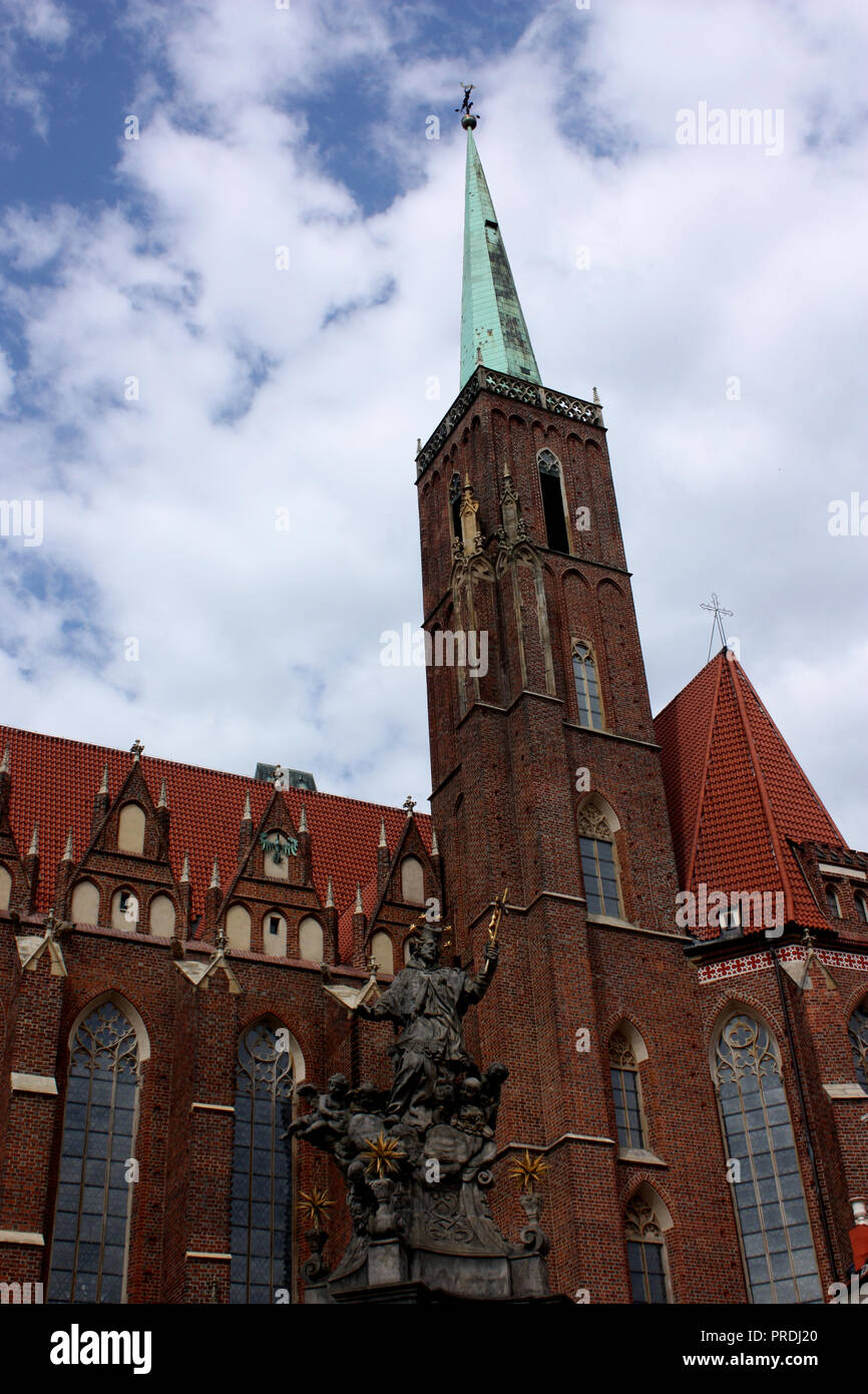 L'église de St Batholomew avec une statue de saint Jean Népomucène en face, à Wroclaw, Pologne Banque D'Images