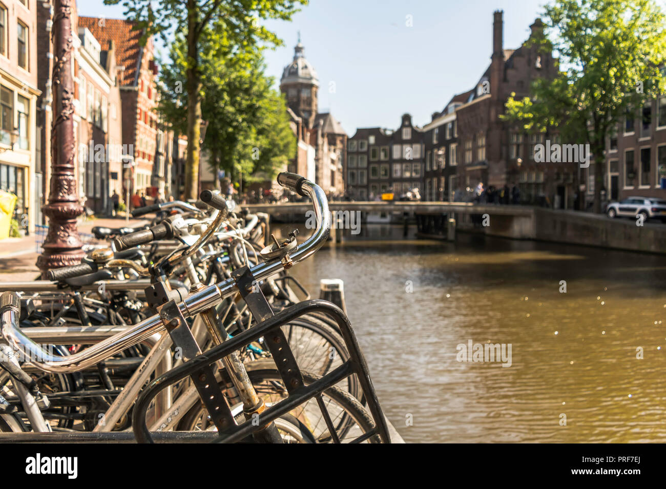 Guidon de vélo à Amsterdam avec le canal et maisons en arrière-plan. Il y a plus de 881 000 bicyclettes en location-friendly Amsterdam. Banque D'Images