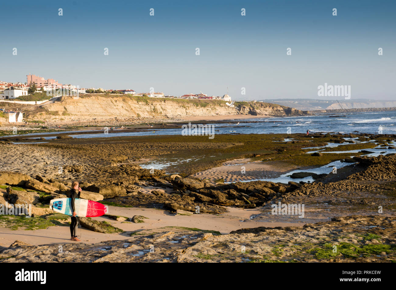 Surfer avec une planche de surf sur la plage de l'APEM, Ericeira, Portugal Banque D'Images