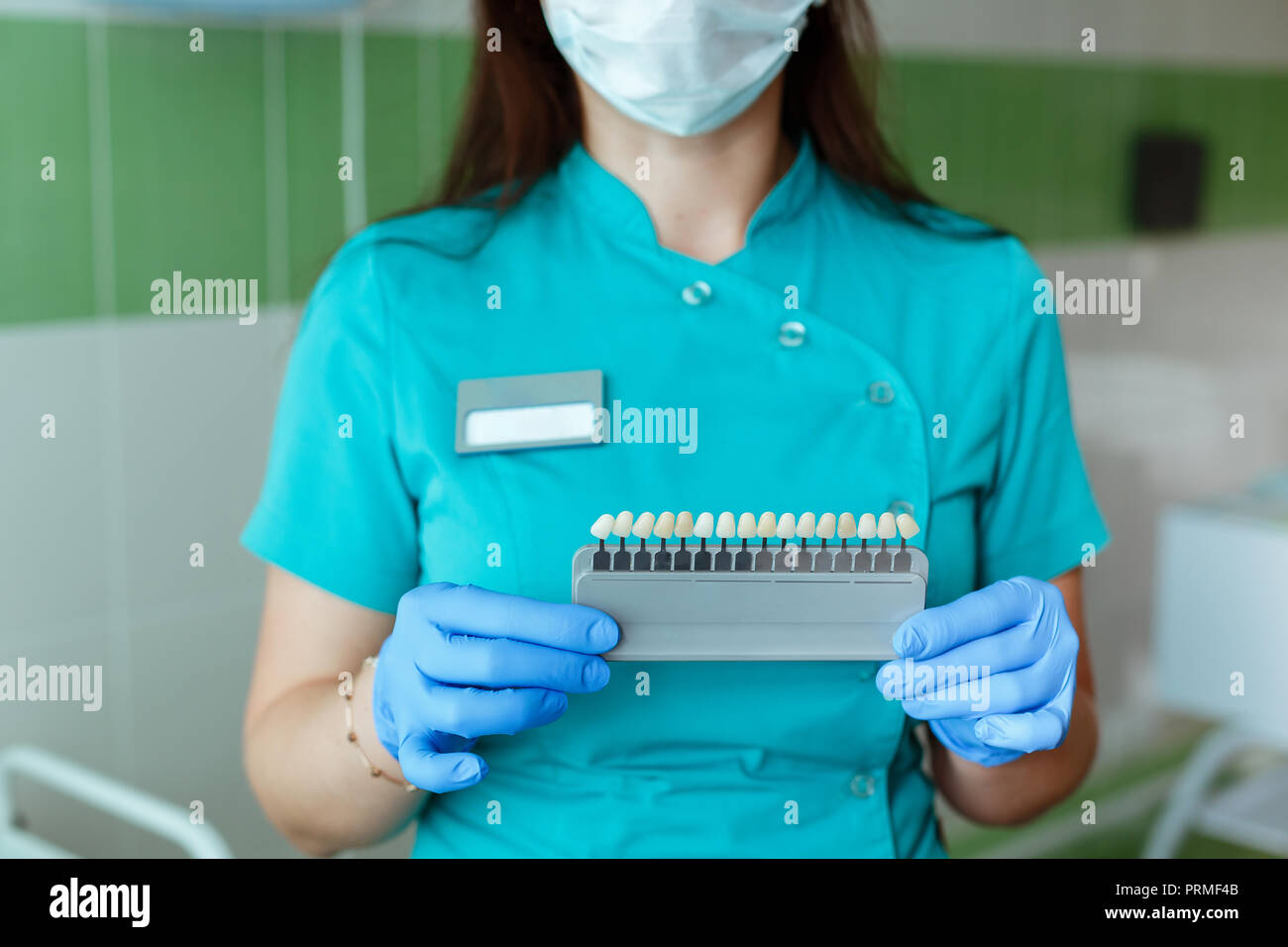 Dentiste tenant dans les mains correspondant aux nuances de couleur ou de l'implant ou le processus de blanchiment des dents. Banque D'Images