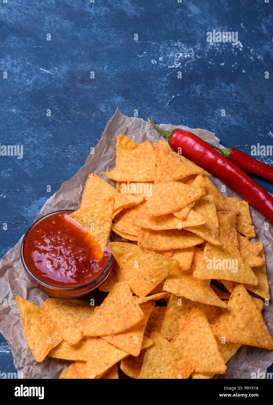 Tortillas mexicaines savoureuses avec salsa aux tomates sauce sur fond de béton bleu foncé. Banque D'Images
