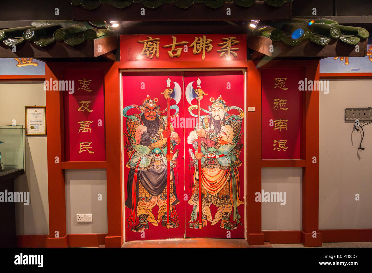 Une porte rouge avec des divinités ou connu sous le nom de Men Shen, Johor Bahru Musée du patrimoine chinois. Malaisie. Banque D'Images