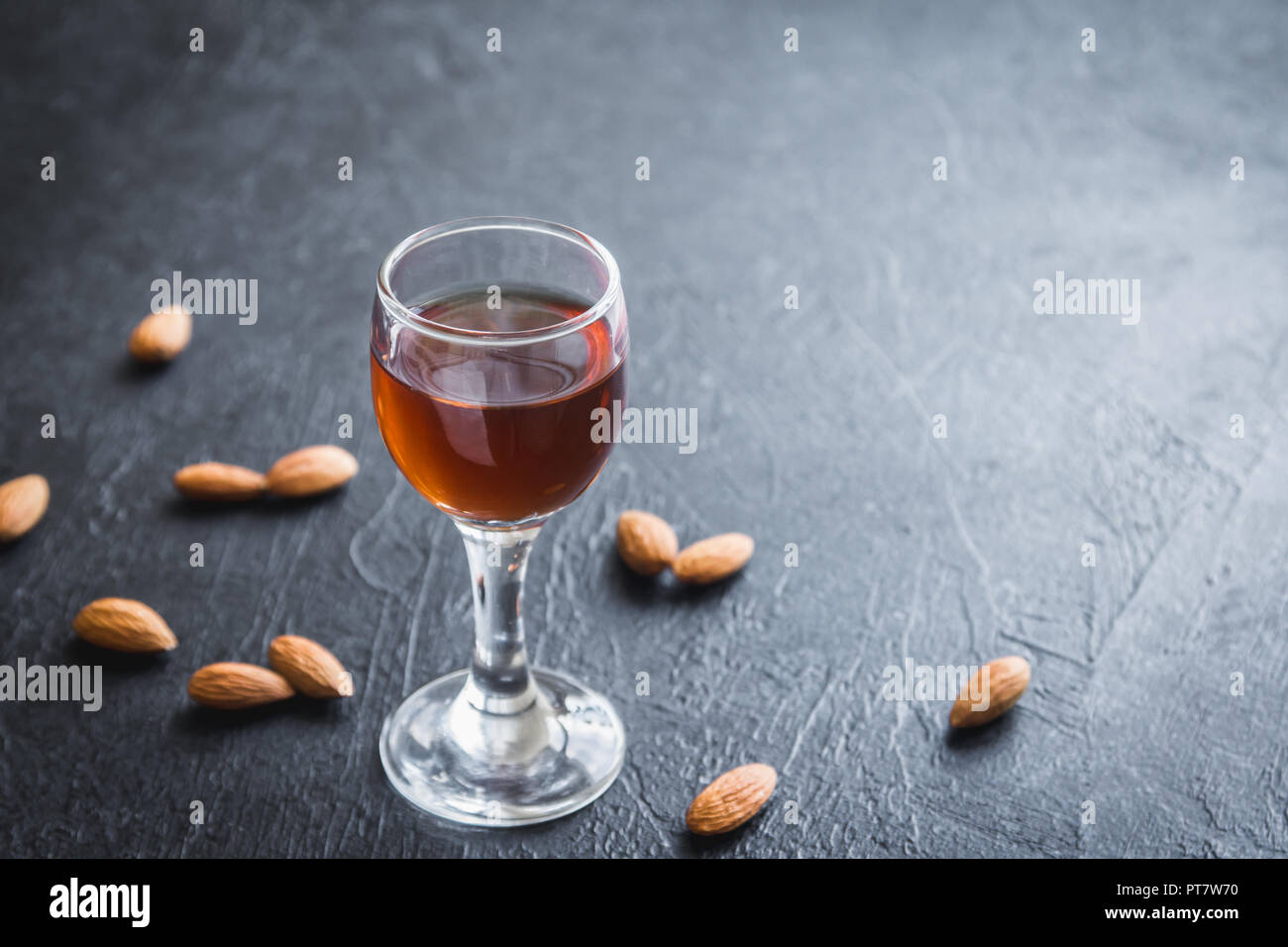 Amaretto Liqueur italienne aux amandes sur fond noir en noir, copy space Banque D'Images