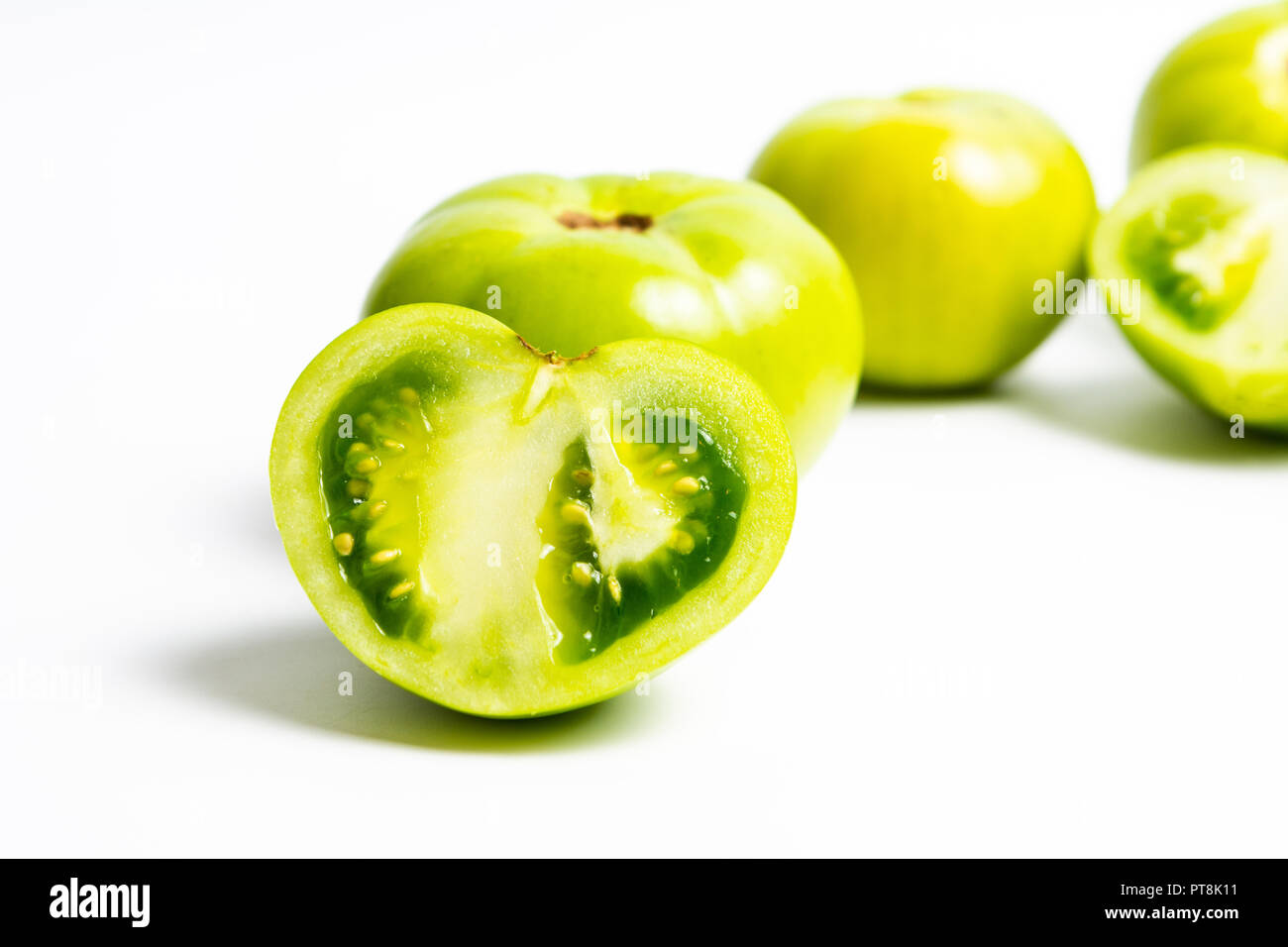 Tranches de tomate verte sur fond blanc Banque D'Images