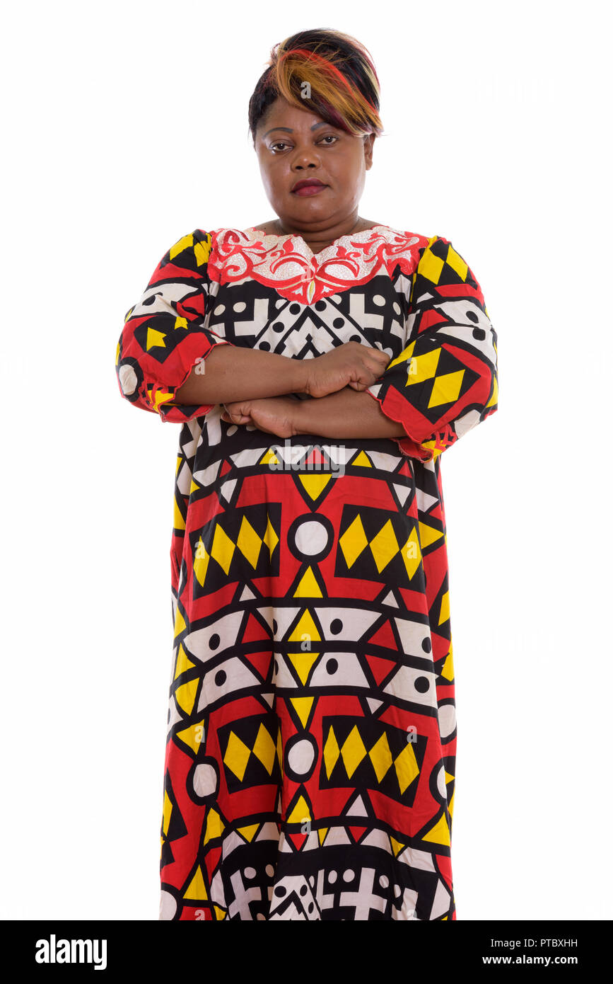 Studio shot of fat black African woman standing with arms crosse Banque D'Images