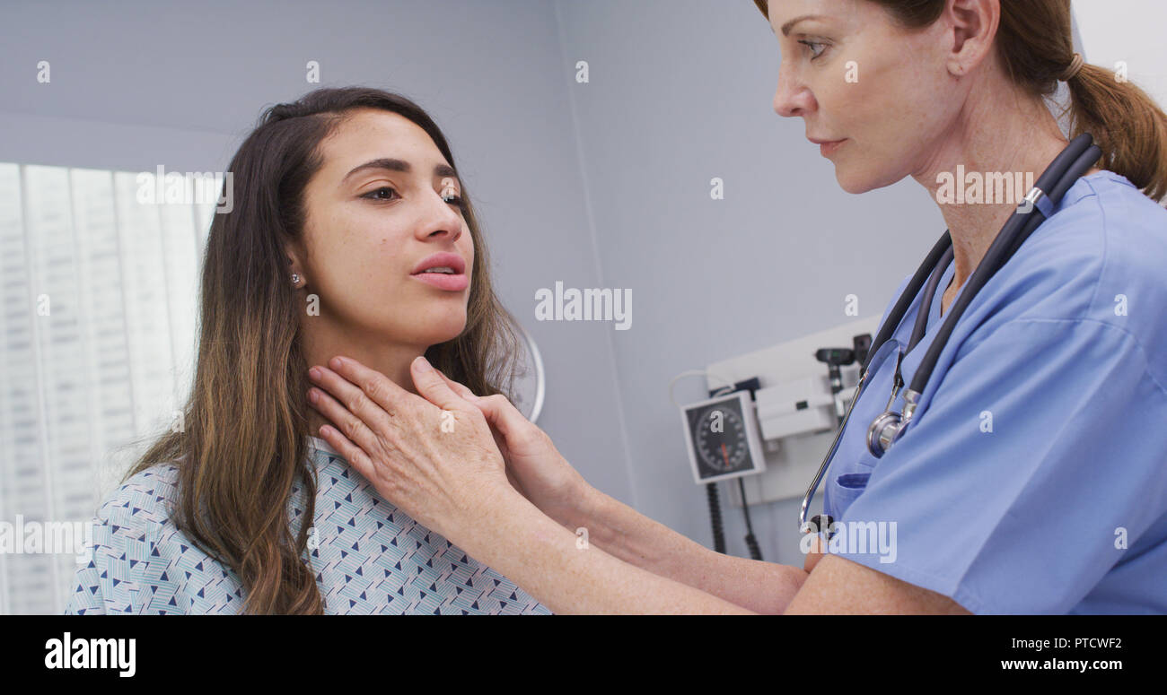 Infirmière examine les ganglions sur le cou de womans pour déterminer si enflé Photo Stock Alamy