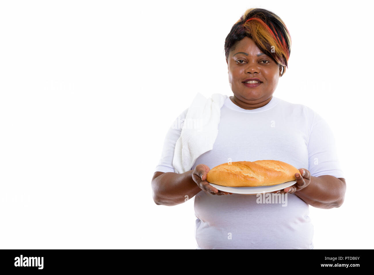 Studio shot of happy fat black African woman smiling while holdi Banque D'Images