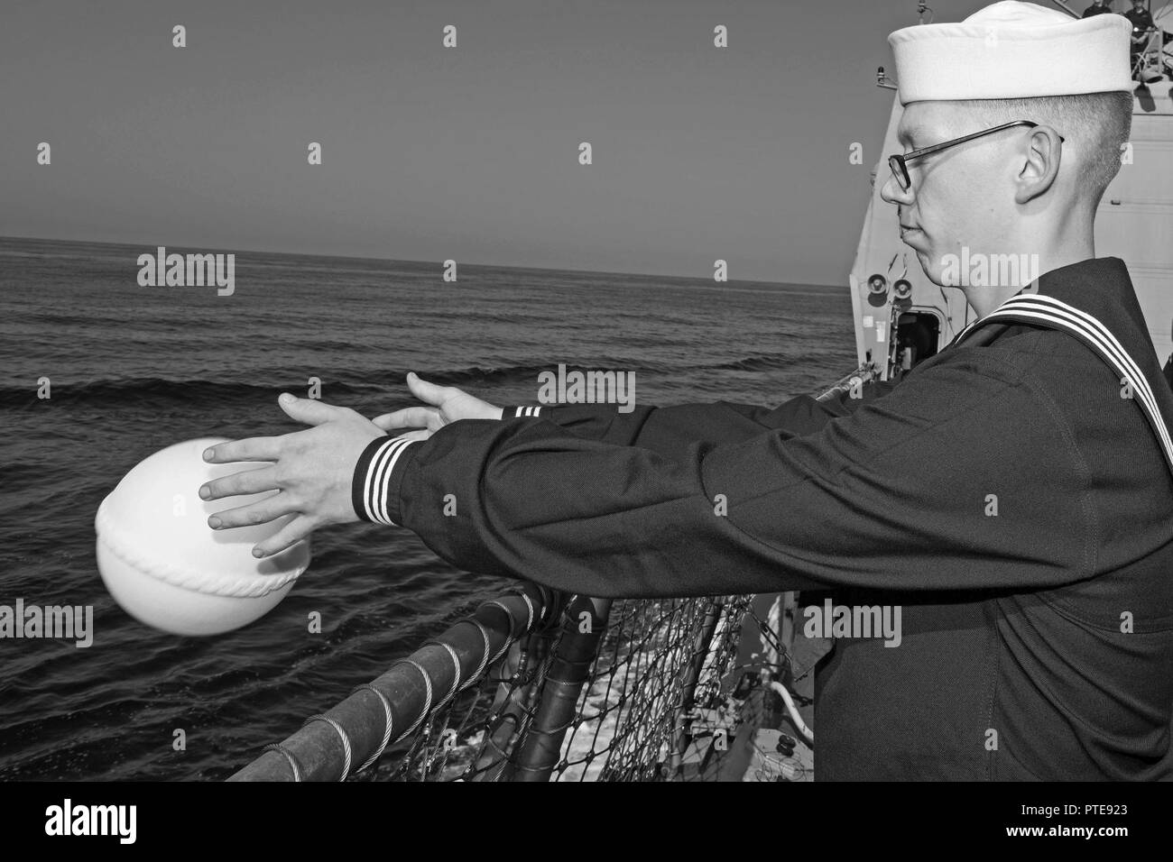 Mer Méditerranée (16 juillet 2017) pompier Zackary Palmer lieux cérémonieusement les cendres d'un ancien combattant dans l'océan pendant un enterrement en mer à bord de la cérémonie missiles USS Truxtun (DDG 103). Truxtun, partie de la George H. W. Groupe aéronaval du Bush (GHWBCSG), mène des opérations navales dans la sixième flotte américaine zone d'opérations à l'appui de la sécurité nationale des États-Unis en Europe et en Afrique. Banque D'Images
