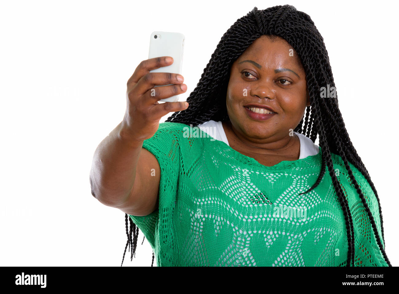 Studio shot of happy fat black African woman smiling while takin Banque D'Images