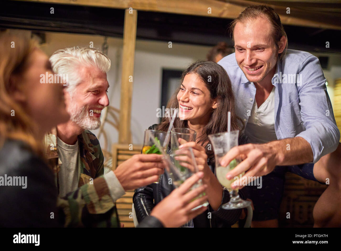 Friends toasting cocktails on patio Banque D'Images