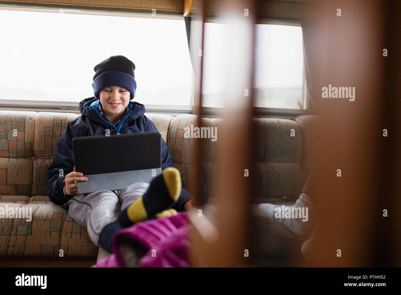 Teenage boy using digital tablet in motor home Banque D'Images