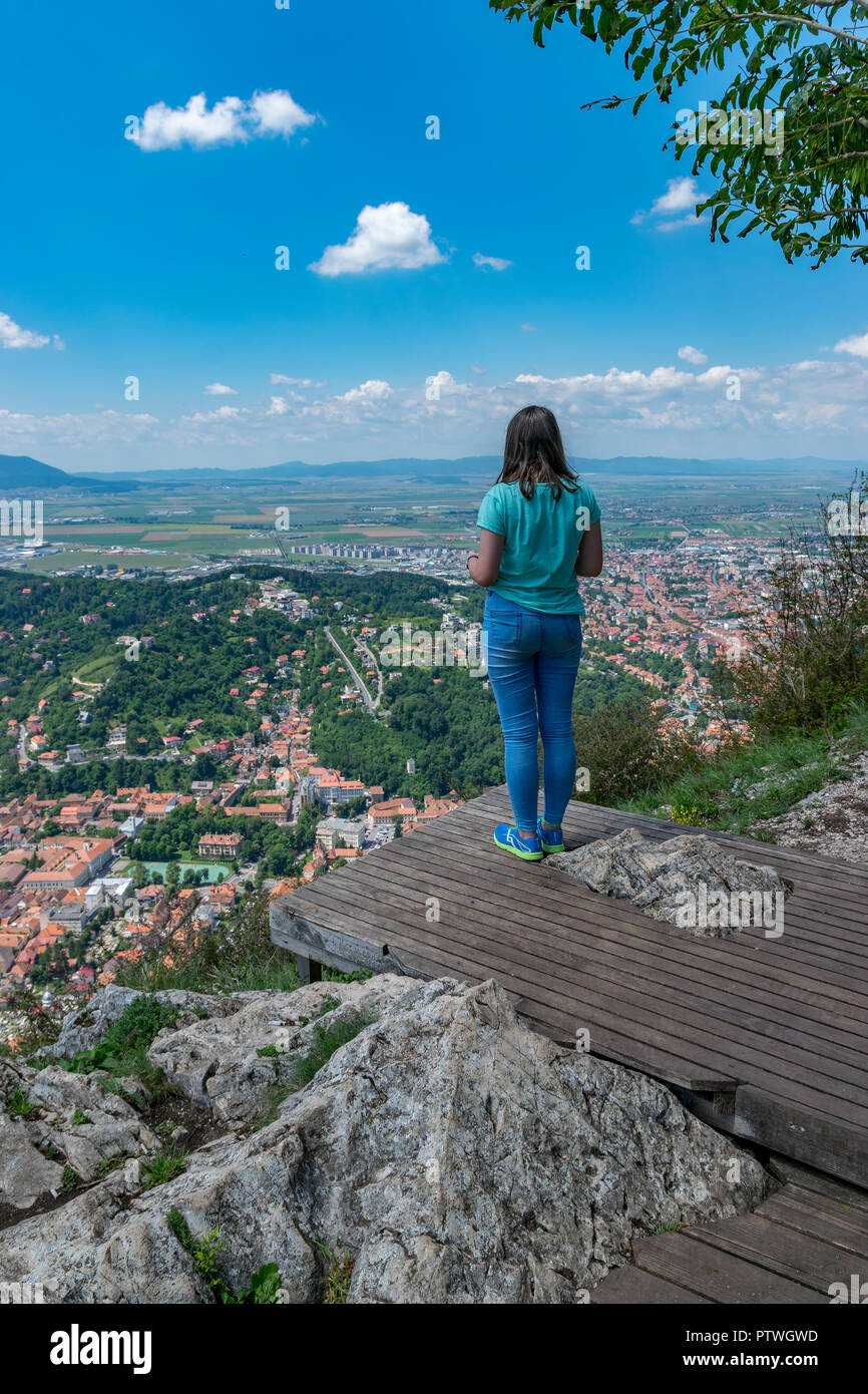 Girl admiring la ville de Brasov aperçu de la montagne Tampa à Brasov, Roumanie. Banque D'Images