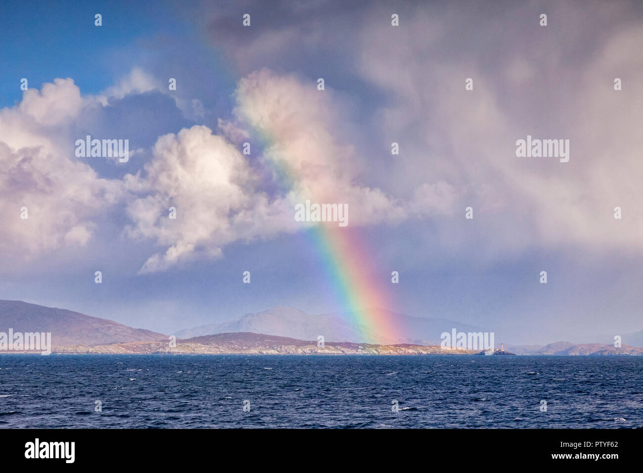Vue depuis la mer de rainbow et phare Eilean Glas approche du port de Tarbert sur l'île de Harris, îles Hébrides, Ecosse, Royaume-Uni. Banque D'Images