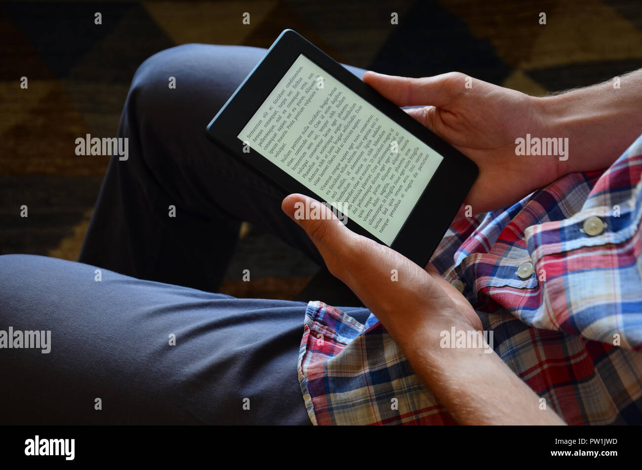 La lecture de l'homme ebook sur son lecteur de livres électroniques. Banque D'Images
