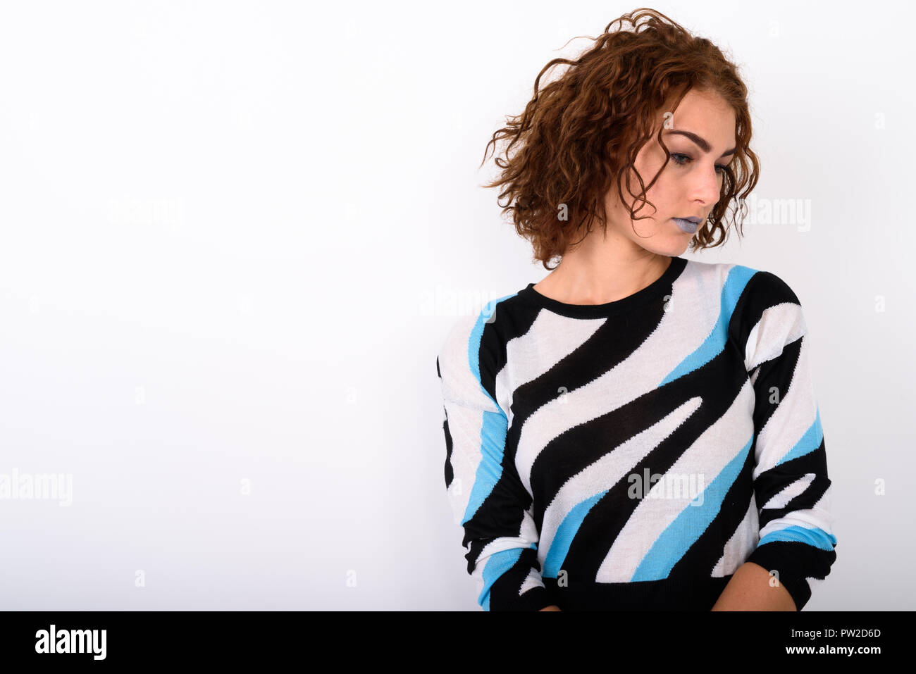 Portrait of Young Woman Thinking Against White Background Banque D'Images