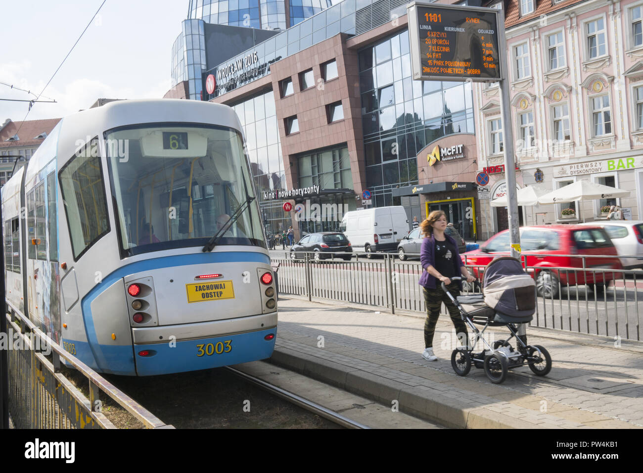 Femme pousse un landau dans un tram dans Wroclaw, Pologne. Banque D'Images