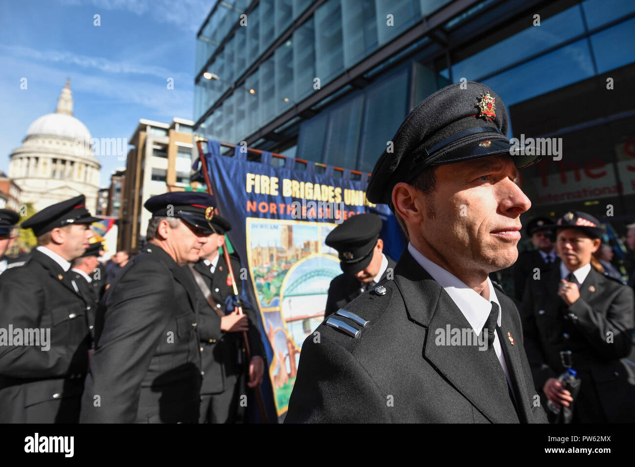Londres, Royaume-Uni. 13 octobre 2018. Après une cérémonie de dépôt à l'échelle nationale à la mémoire des pompiers à côté de la Cathédrale St Paul, à la mémoire de pompiers morts représentant chaque service d'incendie au Royaume-Uni, les membres de l'Union européenne de lutte contre l'incendie (FBU) prendre part à un défilé officiel à travers le Millennium Bridge suivi d'un service à la cathédrale de Southwark pour commémorer le centenaire de la création de la FBU. Les activités sont les plus importantes jamais cérémonie pour les pompiers tués en service. Crédit : Stephen Chung / Alamy Live News Banque D'Images