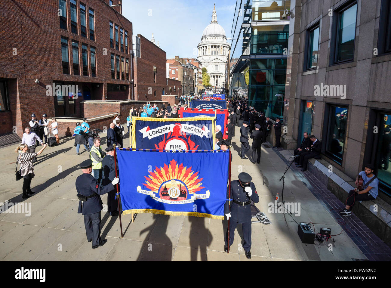 Londres, Royaume-Uni. 13 octobre 2018. Après une cérémonie de dépôt à l'échelle nationale à la mémoire des pompiers à côté de la Cathédrale St Paul, à la mémoire de pompiers morts représentant chaque service d'incendie au Royaume-Uni, les membres de l'Union européenne de lutte contre l'incendie (FBU) prendre part à un défilé officiel à travers le Millennium Bridge suivi d'un service à la cathédrale de Southwark pour commémorer le centenaire de la création de la FBU. Les activités sont les plus importantes jamais cérémonie pour les pompiers tués en service. Crédit : Stephen Chung / Alamy Live News Banque D'Images