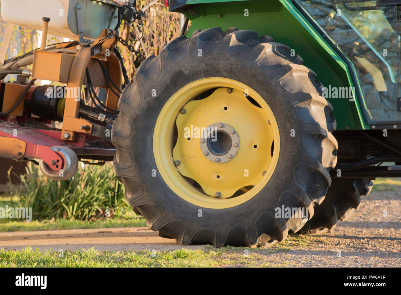 Une des roues du tracteur jaune et noir pneu (pneu) sur un tracteur vert à Rowlee Winery à Nashdale près d'Orange Nouvelle Galles du Sud, Australie Banque D'Images
