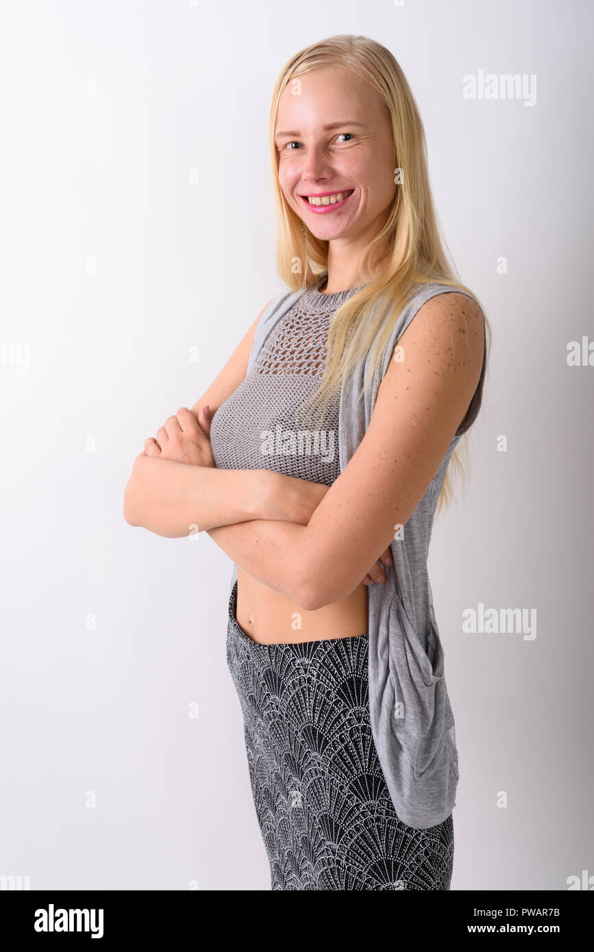 Belle blonde woman standing against white background Banque D'Images