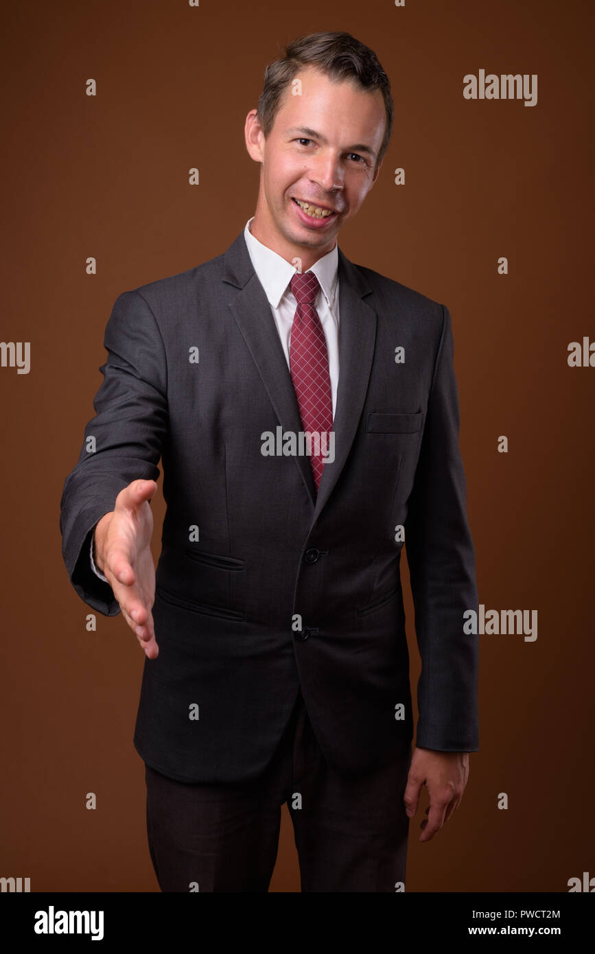 Studio shot of businessman contre fond brun Banque D'Images