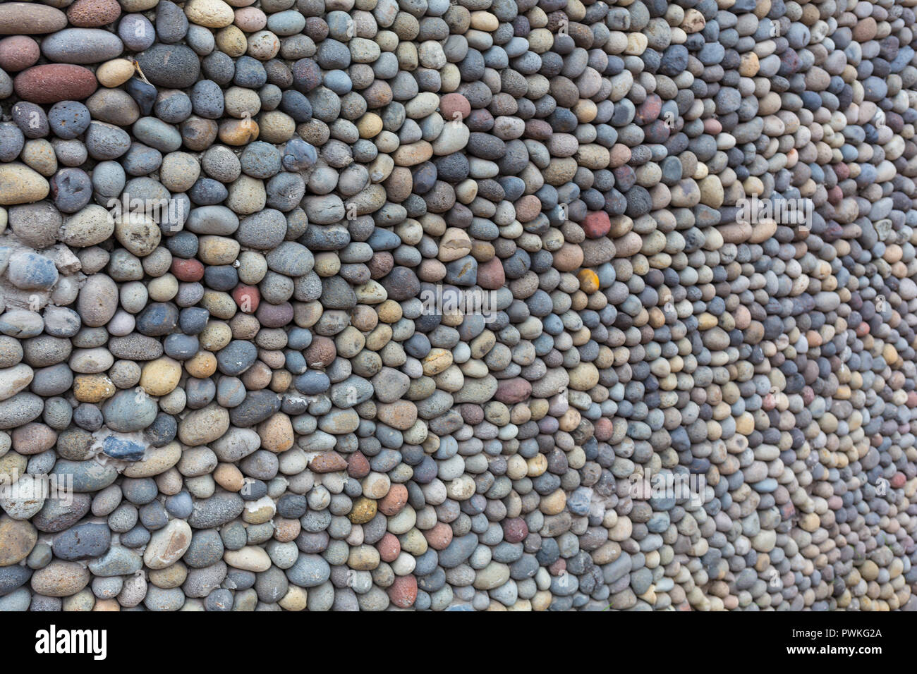 La texture de fond, paroi constituée de petites pierres de rivière. Banque D'Images