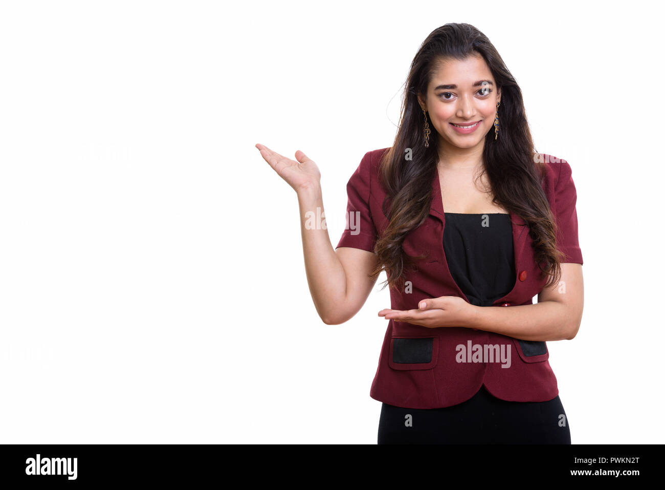 Studio shot of young happy Indian businesswoman smiling while sh Banque D'Images