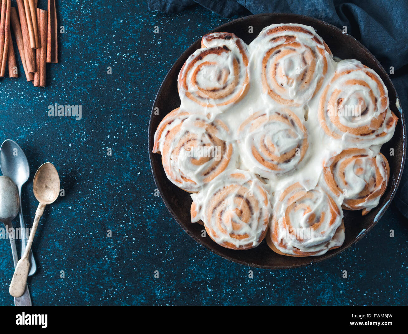 Idée recette et pâtisseries - parfait à la cannelle avec topping, vue du dessus dans la poêle. Brioches à la cannelle suédois Vegan Kanelbullar avec pumpkin spice,topping crème vegan cheese.Télévision. L'espace de copie pour le texte Banque D'Images