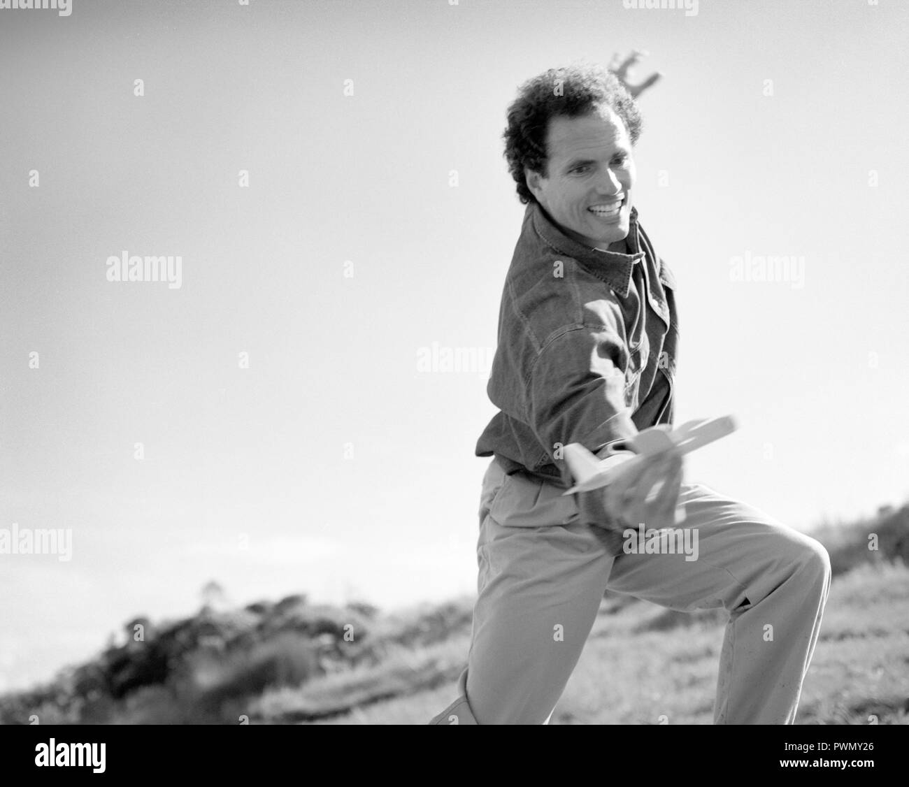 Mid-adult man Playing with toy airplane. Banque D'Images