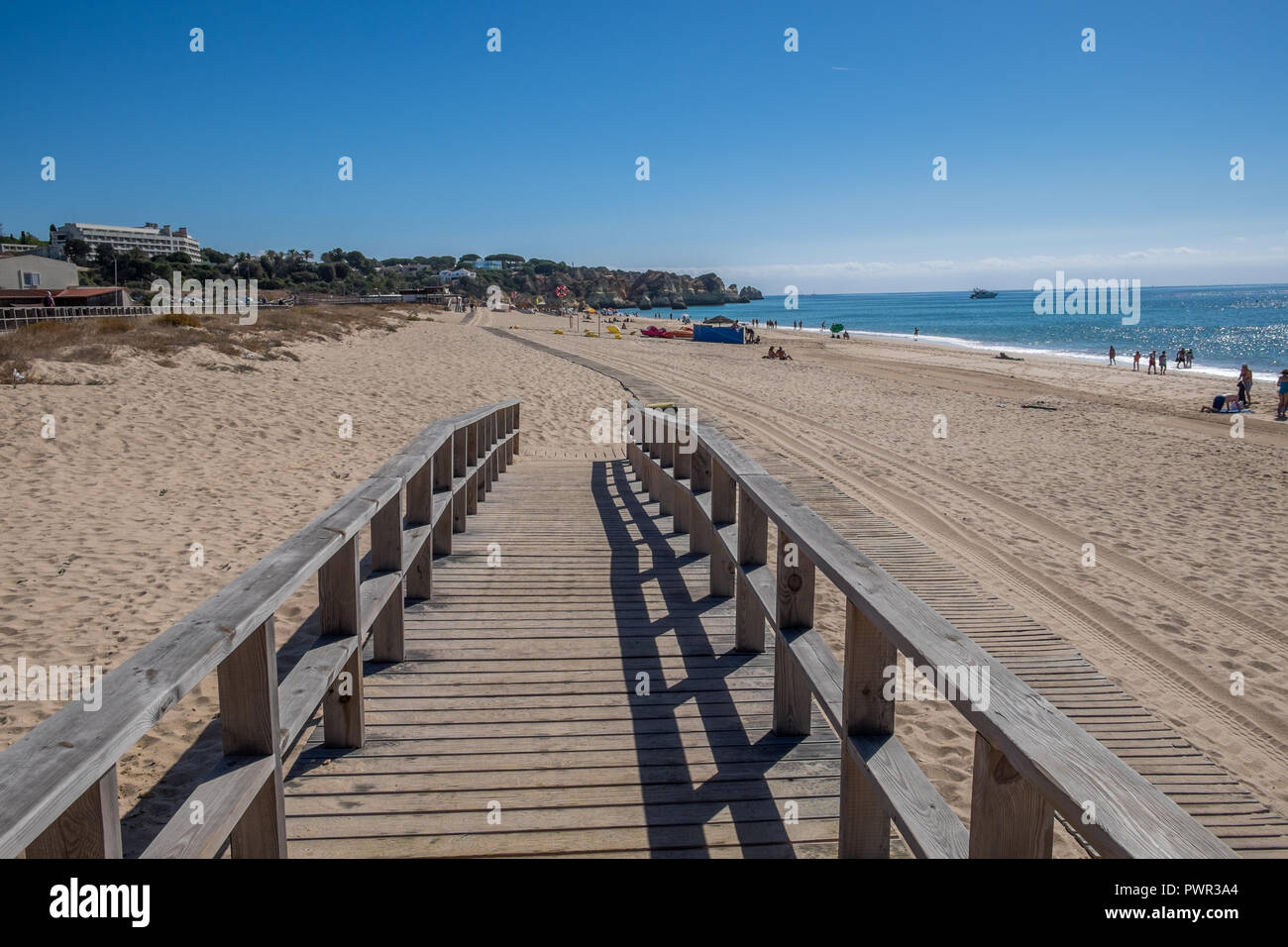 Promenade menant à la plage avec quelques chaises longues. Banque D'Images