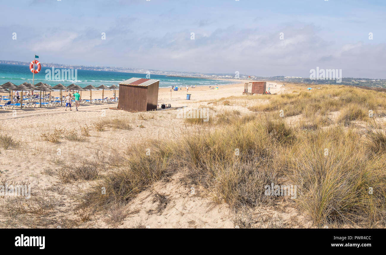 Promenade menant à la plage avec quelques chaises longues. Banque D'Images