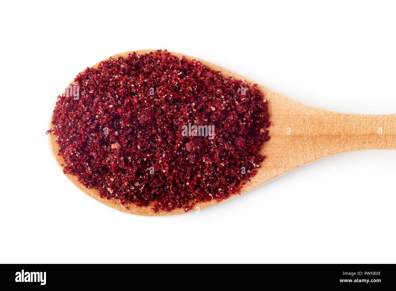 Sumac moulu poudre épices en cuillère en bois isolé sur fond blanc Banque D'Images