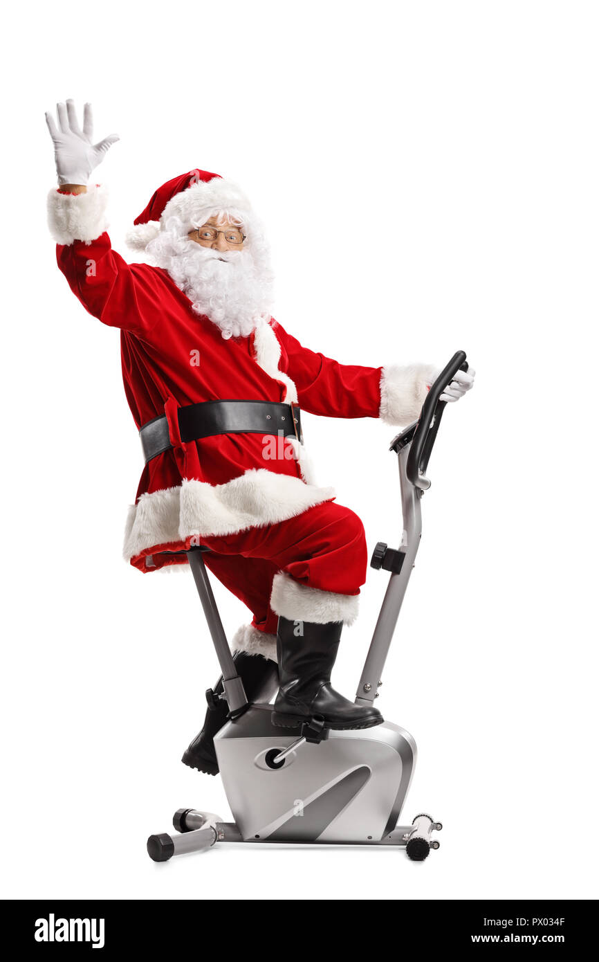 Santa Claus exerçant sur un vélo stationnaire et forme isolé sur fond blanc Banque D'Images