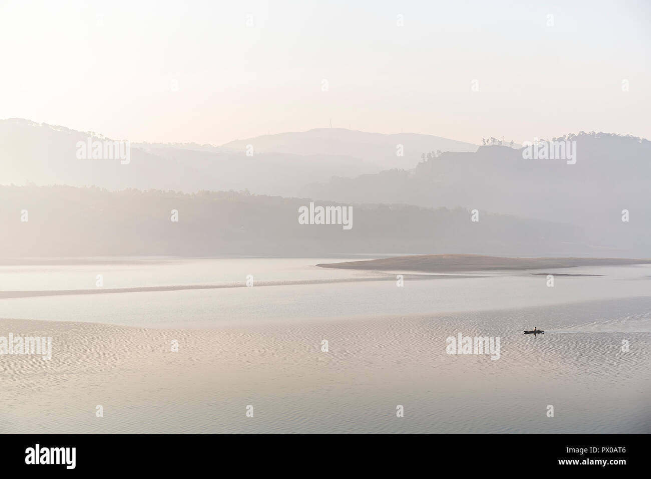 Barque de pêcheur sur Bara Pani Lac sur un matin brumeux, Siloé, Meghalaya, en Inde Banque D'Images