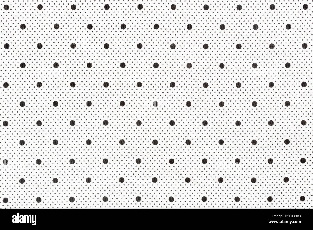 Tissu blanc avec des points noirs comme arrière-plan. Banque D'Images