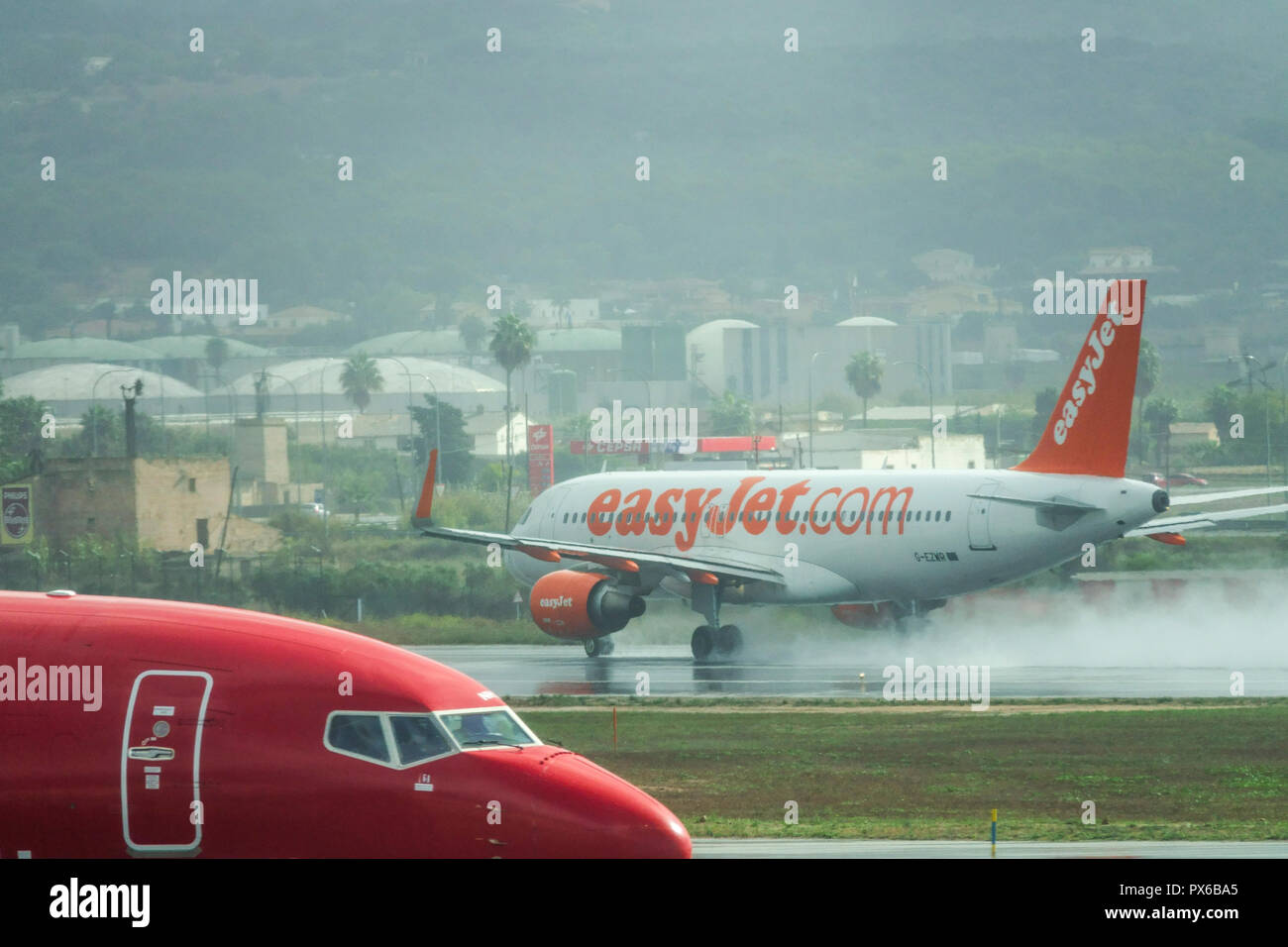 L’avion easyJet décolle sur piste mouillée, Palma de Majorque, Espagne Banque D'Images