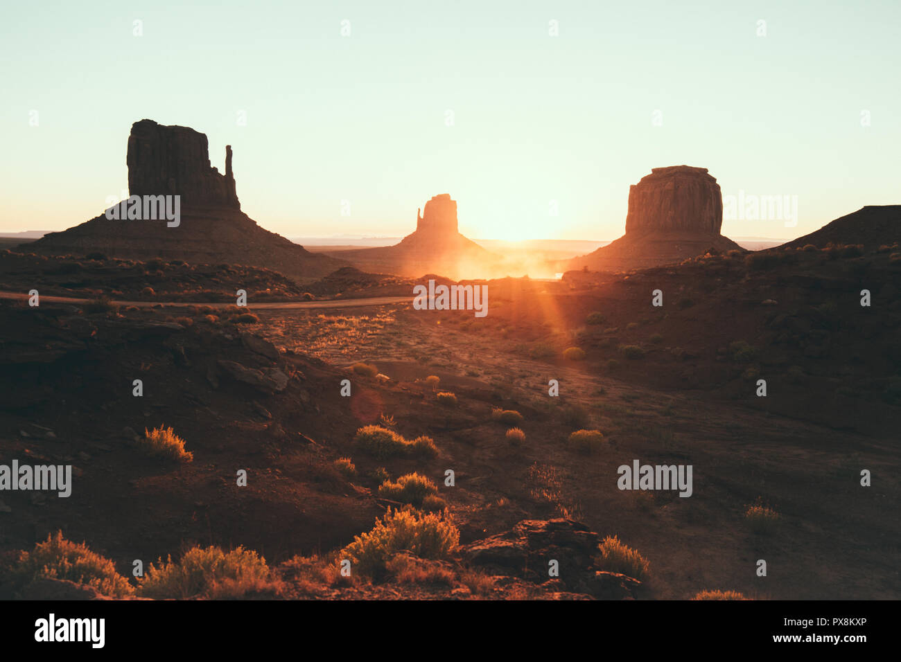 La vue classique du scenic Monument Valley avec la célèbre mitaines et Merrick Butte dans la belle lumière du matin d'or au lever du soleil en été avec retro vin Banque D'Images