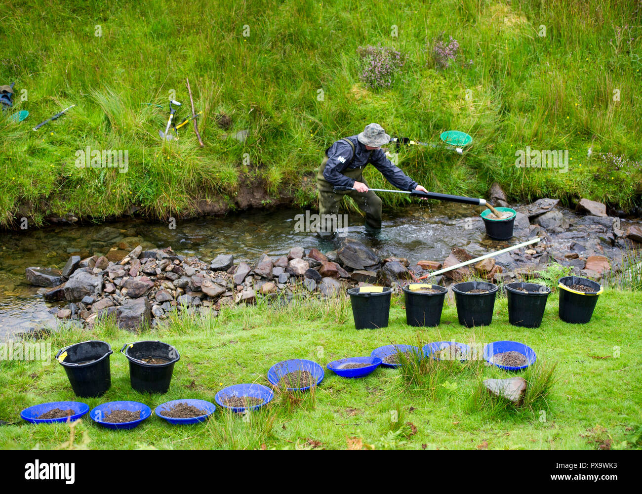 Cours de l'or à la batée pour les visiteurs et les touristes sur l'eau près de Wanlockhead Mennock, en Écosse. Banque D'Images