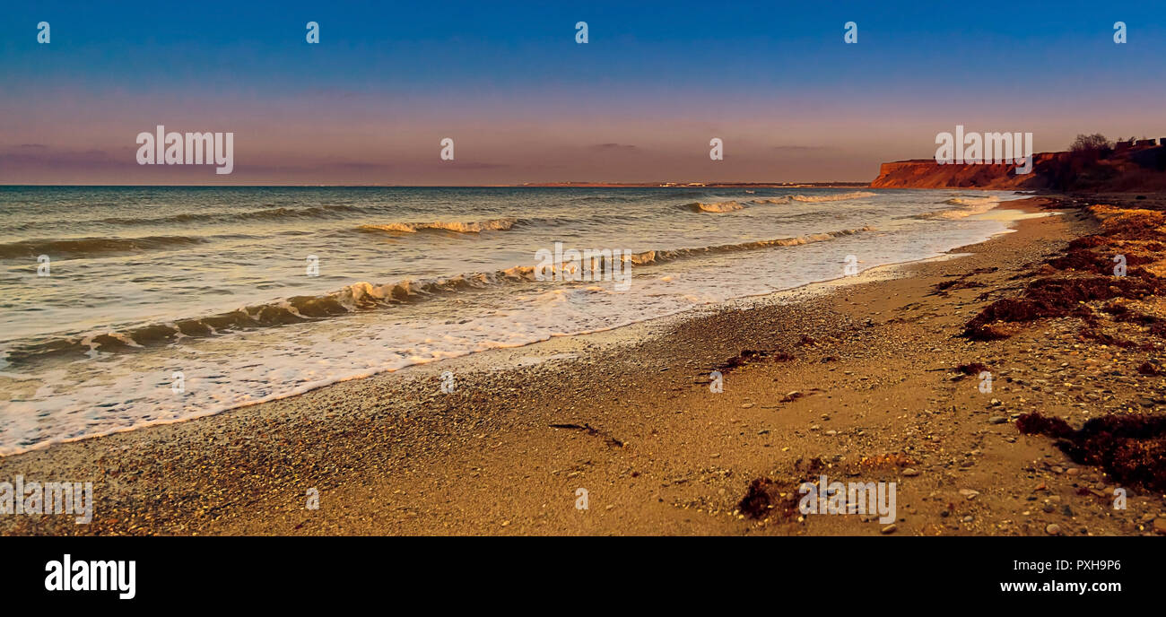 Vagues de la mer Noire, des algues sur la plage, Coucher de soleil sur la plage du Cap, l'hiver est vide Banque D'Images