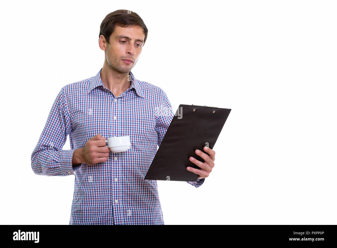Studio shot of young handsome businessman holding Coffee cup et Banque D'Images