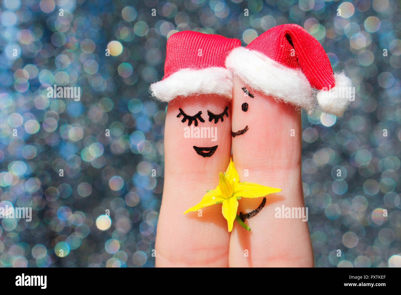 L'art du doigt un couple heureux fête Noël. L'homme est donnant des fleurs à une femme. Banque D'Images