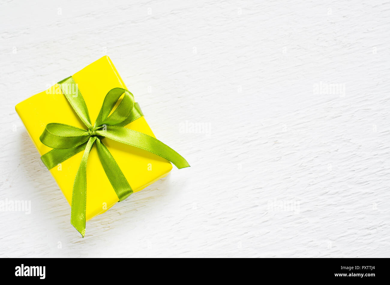 Present Pour La Fete Des Meres Saint Valentin Ou D Anniversaire Boite Cadeau Enveloppe Dans Du Papier Jaune Avec Un Ruban Vert Sur Fond Vintage En Bois Blanc Copy Space Photo Stock Alamy