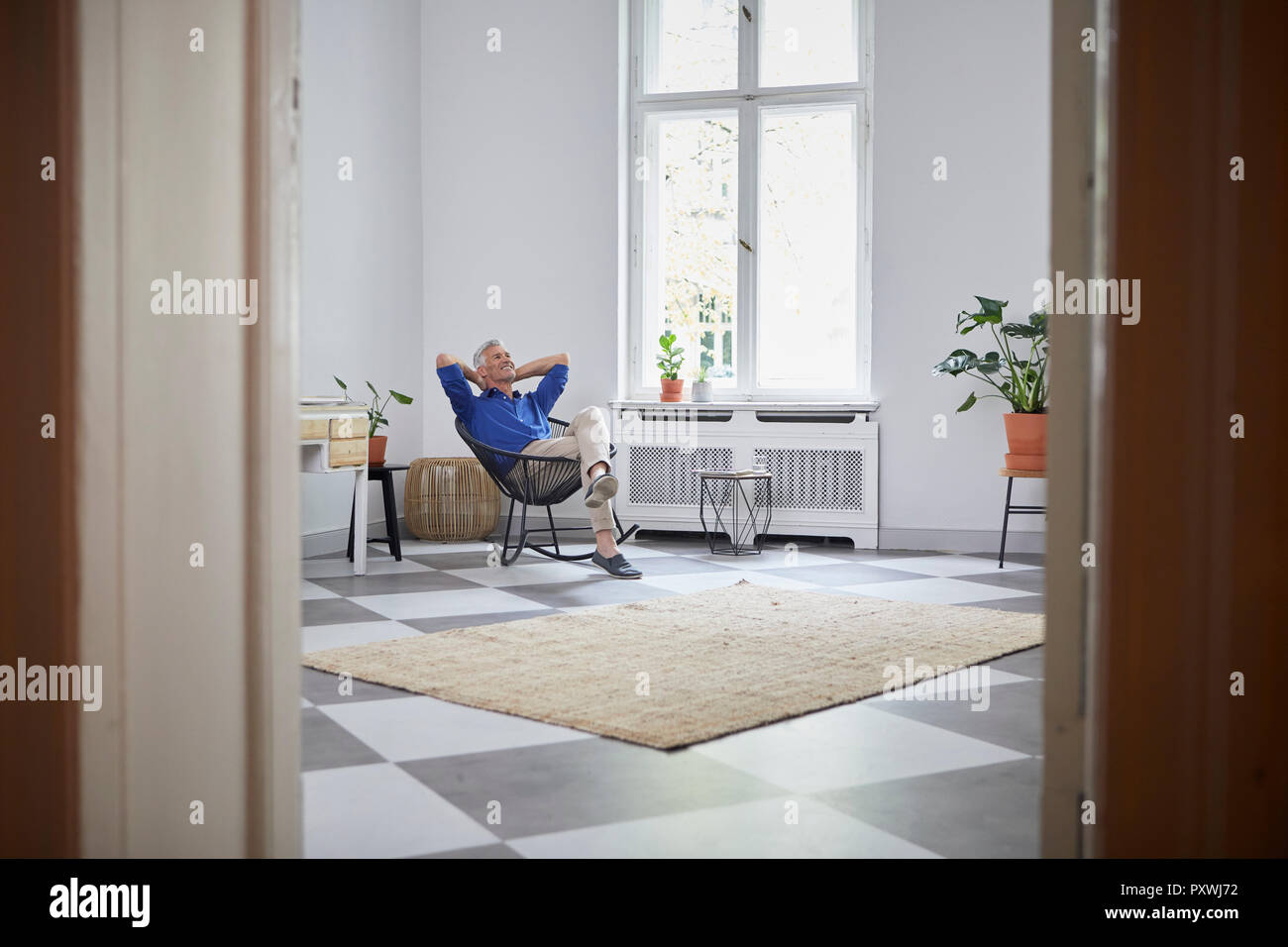 Relaxed mature man sitting at home Banque D'Images