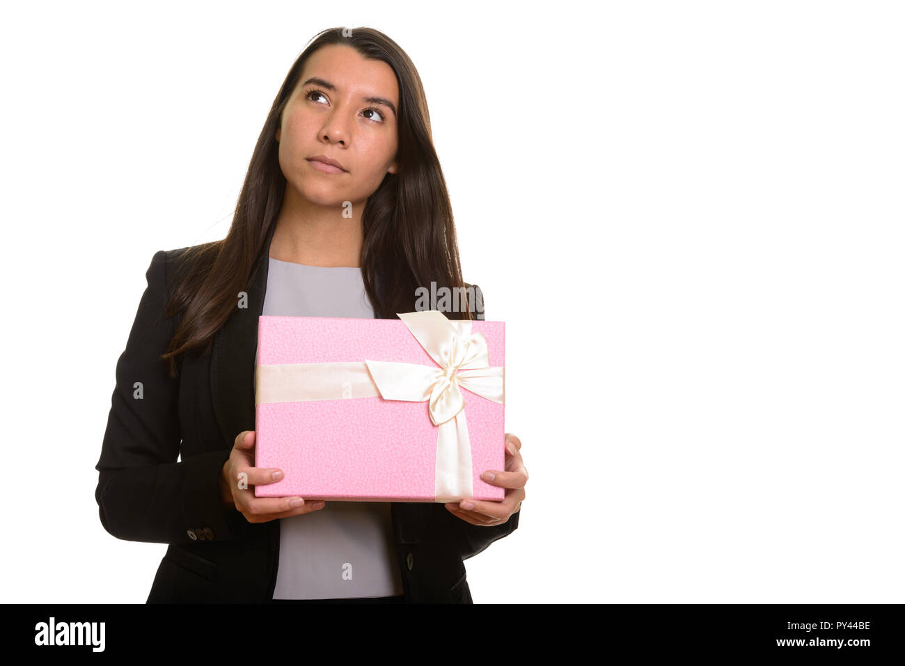 Young Caucasian businesswoman holding gift box en pensant Banque D'Images