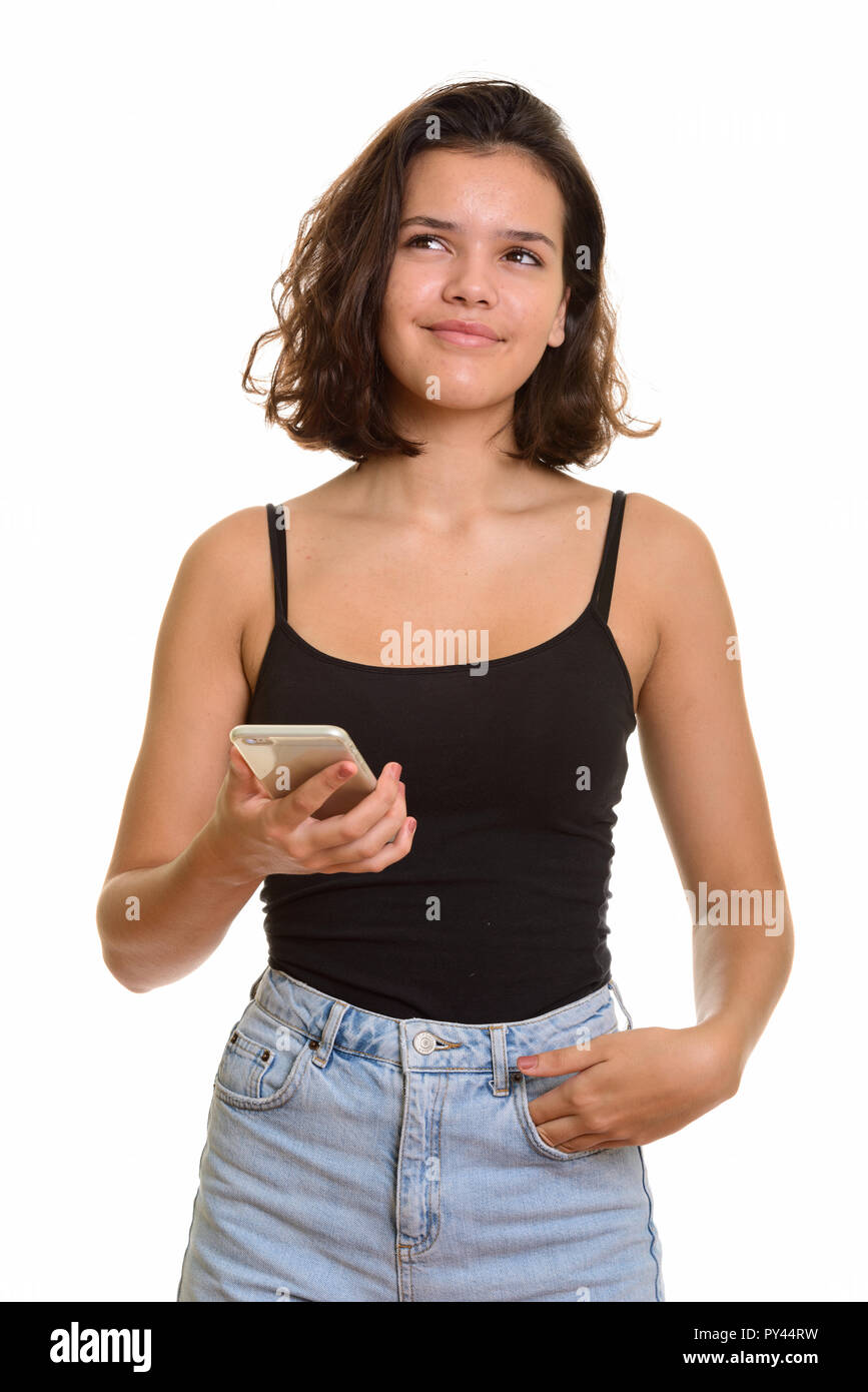 Jeune belle Caucasian teenage girl holding mobile phone whil Banque D'Images