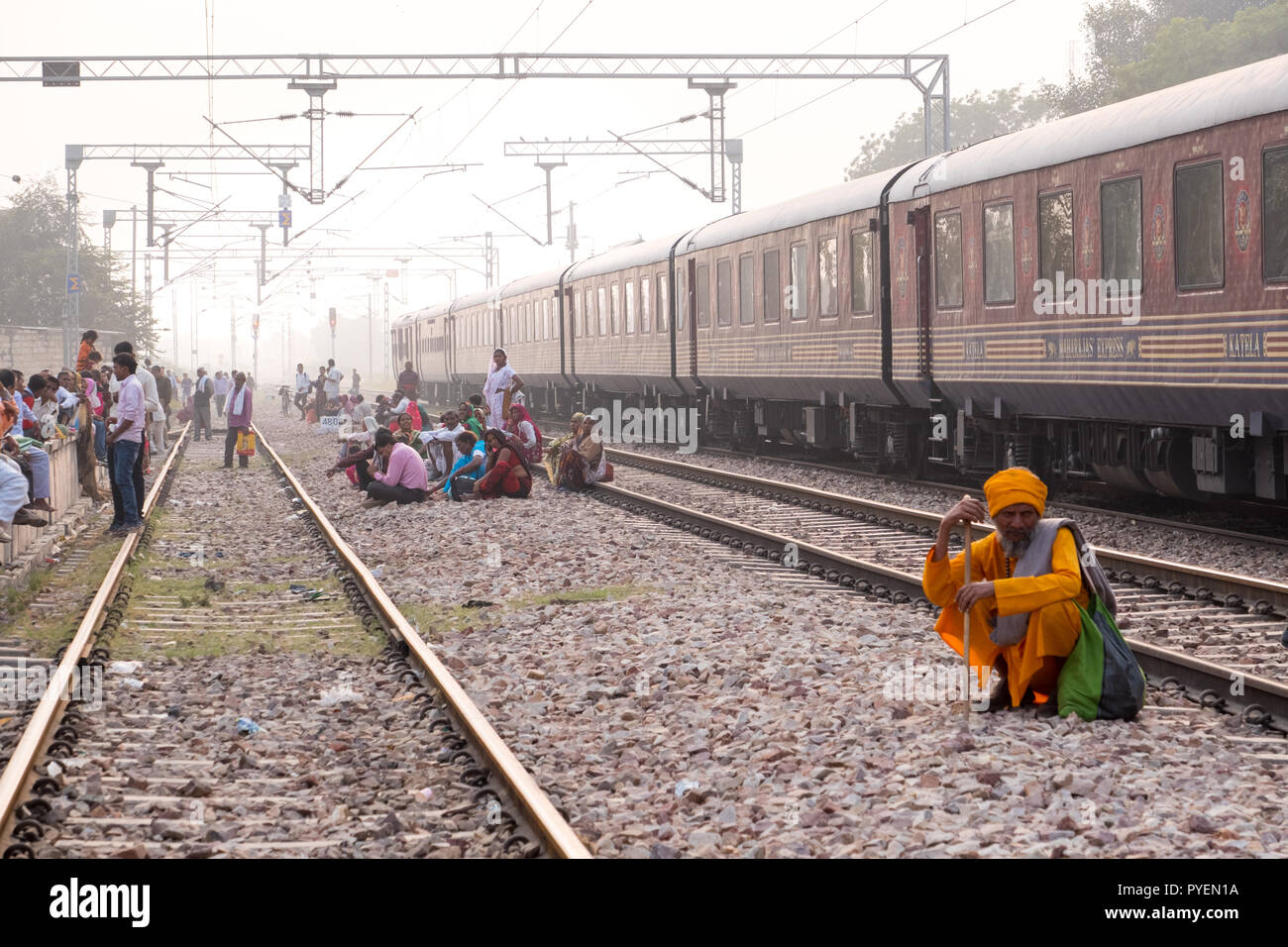 Les passagers qui attendent les Indiens sur la voie ferrée pour un train d'arriver, l'Inde Banque D'Images