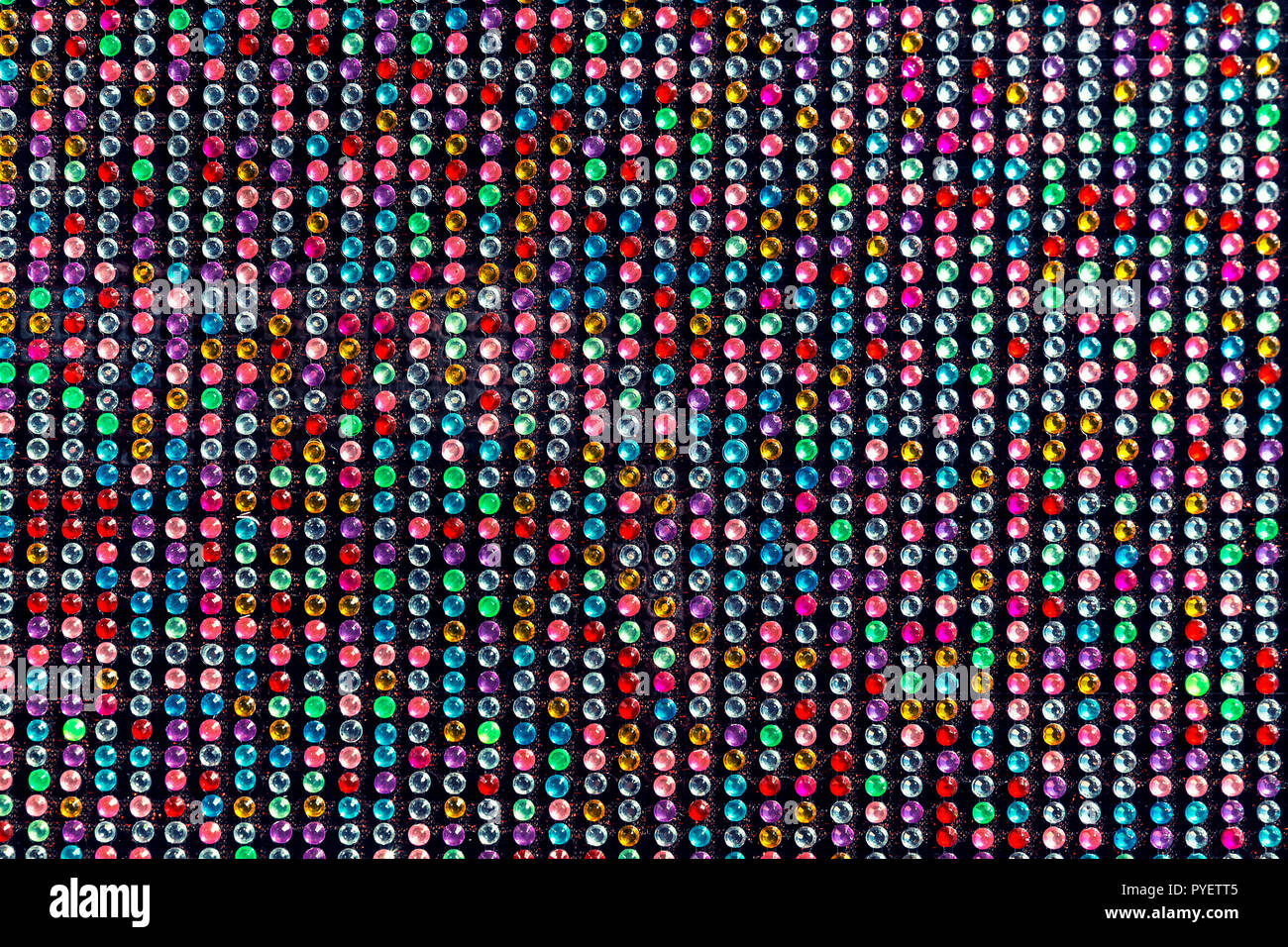 Arrière-plan coloré avec des taches sur la surface en plastique noir Banque D'Images